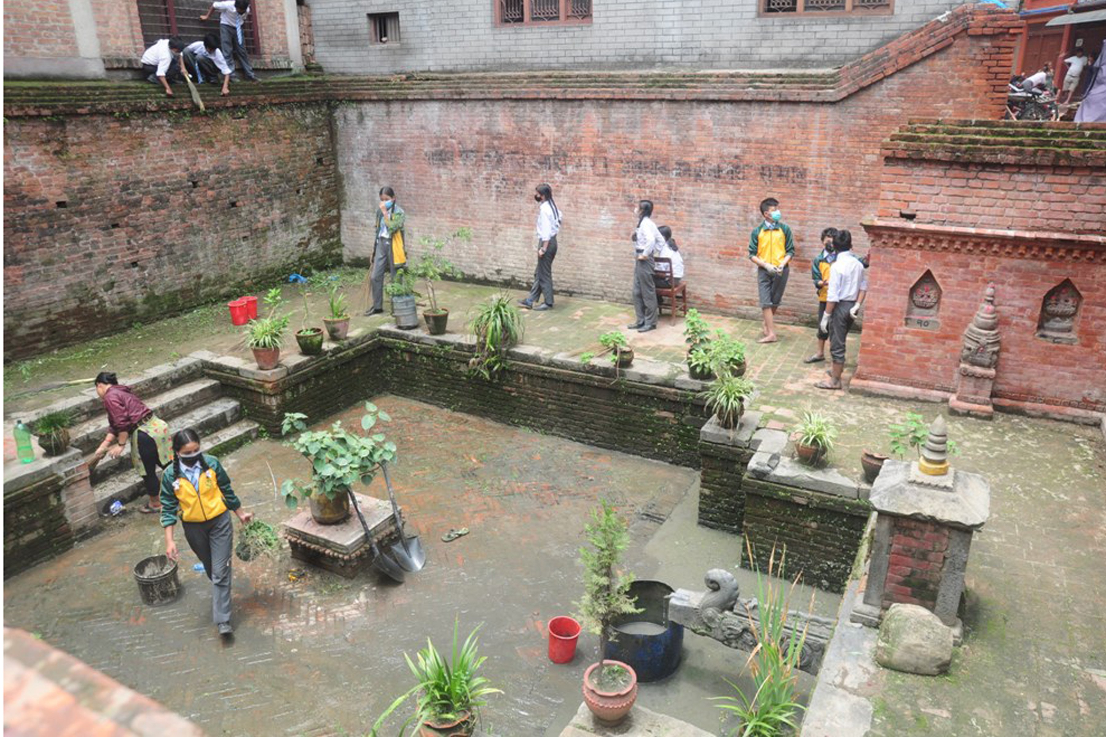 ढुङ्गेधारा वरिपरि सफा गर्दै विद्यार्थी